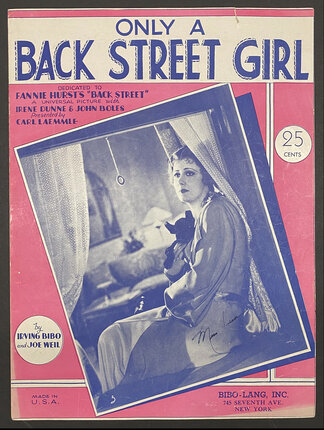 sheet music book cover with a photo of a woman in a silk robe sitting at a window holding a black dog