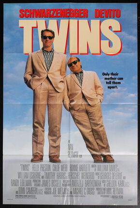 movie poster with two men, one tall and one short dressed identically in suits, and sunglasses. the short one leans on the tall one.