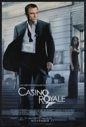 a movie poster of a man in a black suit walking down building steps holding a gun. a woman in an evening gown is standing in the distance.