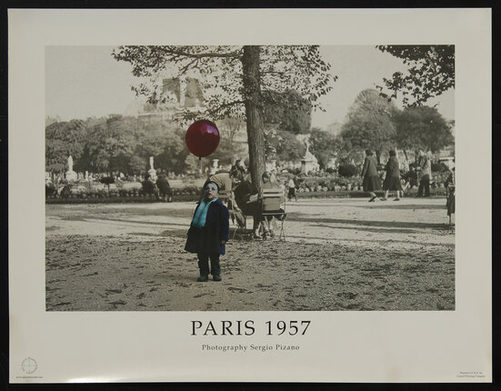 a boy in a park with a balloon