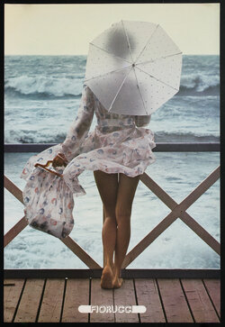 a woman holding an umbrella and standing on a railing